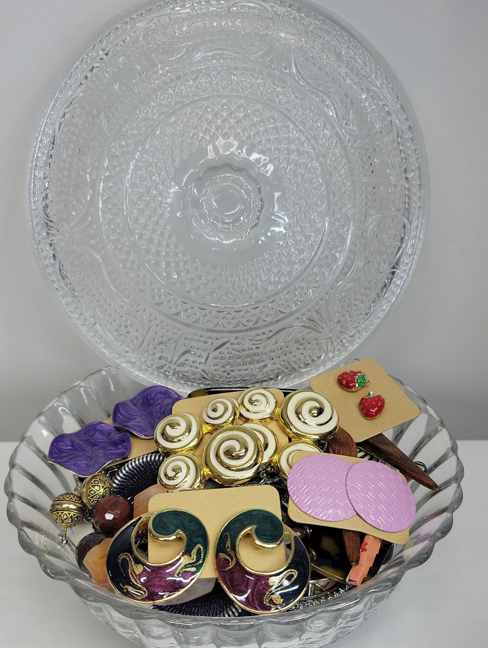 Assorted Earrings In A Glass Candy Dish